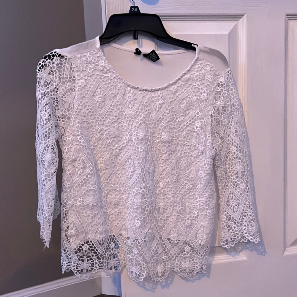 White long sleeve lace patterned shirt.